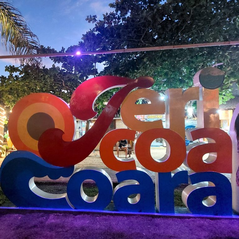 Bunte Buchstaben bilden das Wort "Jericoacoara" vor einem Abendhimmel.