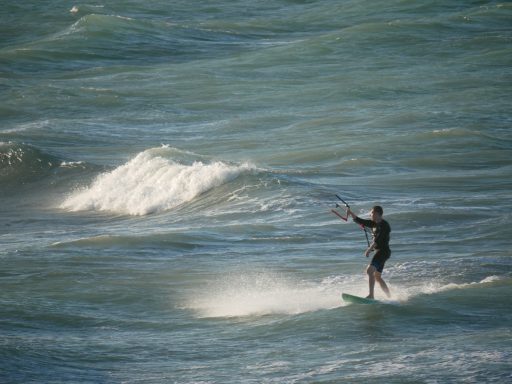 Mann mit Waveboard im Meer, Wellen brechen